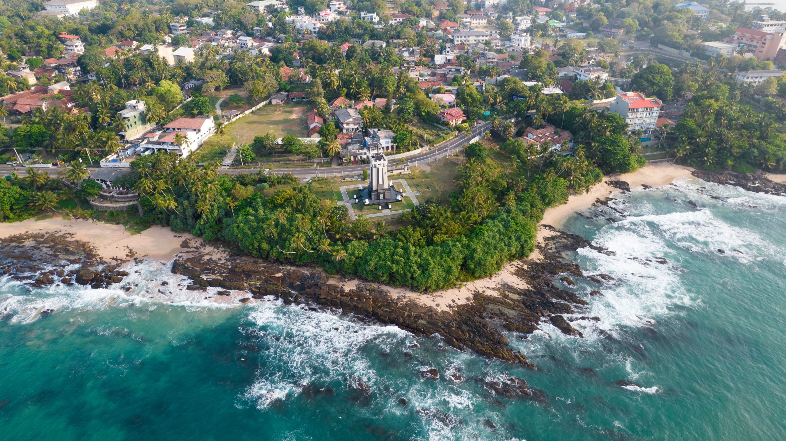 Colombo to Galle Road Trip: What to See 2 Aerial view of turquoise water and a palm-fringed beach on Sri Lanka's southwest coast